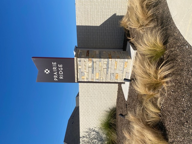 Prairie Ridge entrance monument sign with stacked stone base, Mansfield TX at Goodland master-planned community