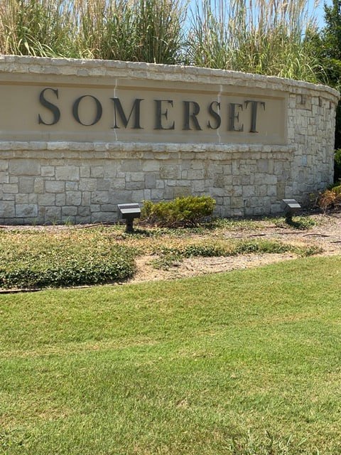 Somerset community entrance monument sign in Mansfield, TX with landscaped stonework