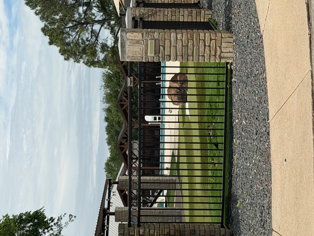 Walnut Creek Country Club pool, putting green, and golf amenities behind ornamental iron fence