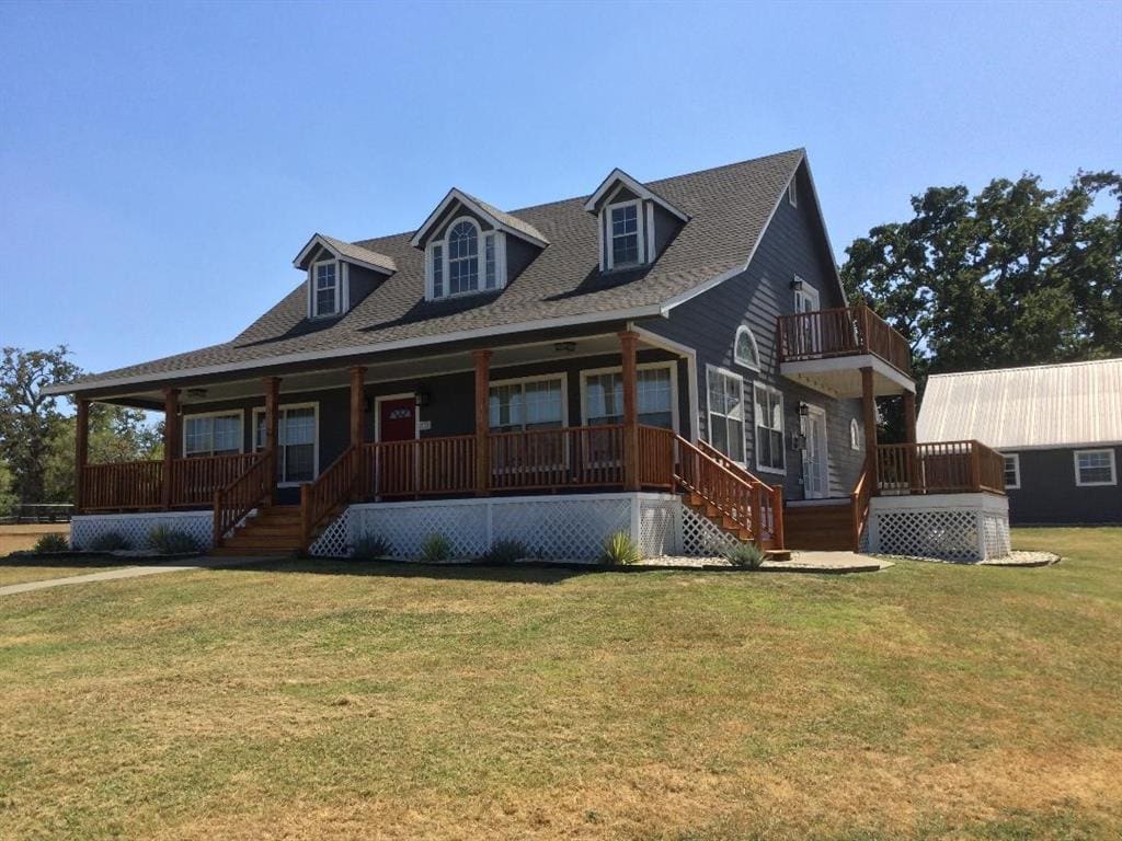 Two-story house with wrap-around porch.