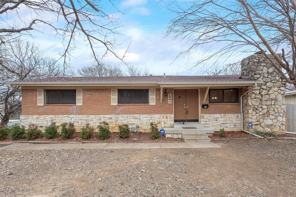 Brick ranch house with double doors.