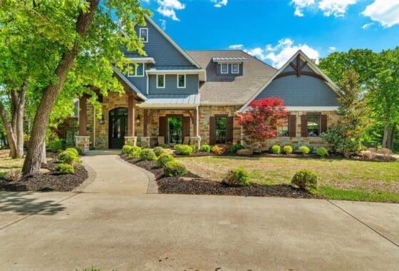 Stone house with landscaped front yard.