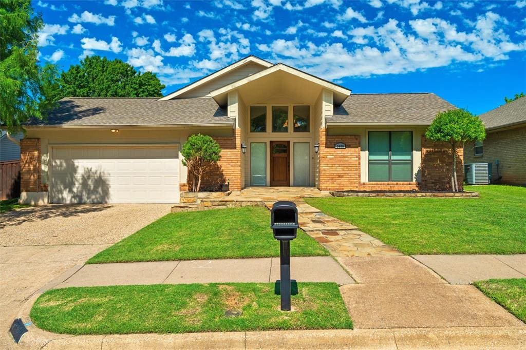 Brick house with garage and mailbox.