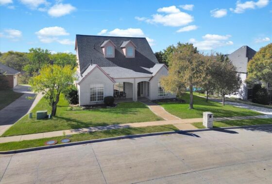 Suburban house with trees and lawn.