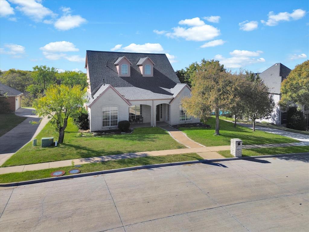Suburban house with trees and lawn.